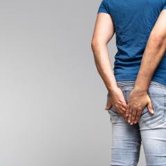 Man holding his bottom