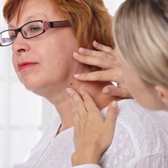 red haired lady having her skin examined