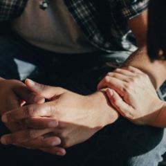 Two people holding hands