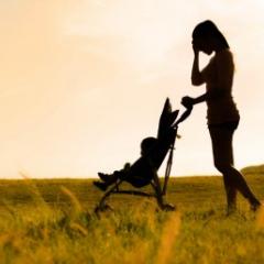 mother walking a baby in a stroller