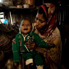 Small child sitting in mother's lap