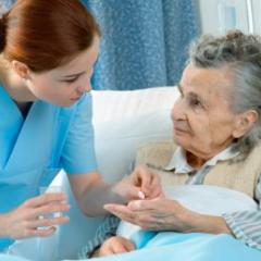 nurse attending to elderly patient