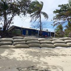 A metre-high wall of sandbags is all that stands between the high tide and the back door of the house, due to rising sea levels. 