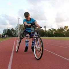 Boy with cerebral palsy using running frame