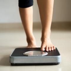 Person standing on a kitchen scale 