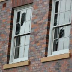 Windows at the Mayne Medical School, UQ’s Herston campus, have been boarded up for safety.