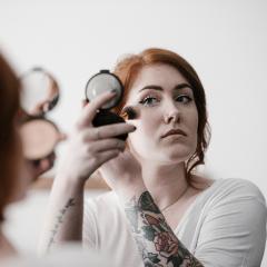 Woman applying powder makeup