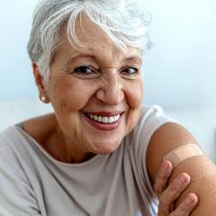 Happy woman with a band aid on her arm